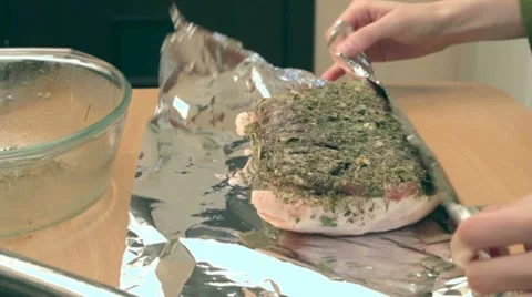 Wraping already cooked pork tightly in foil Stock-Footage 7740877