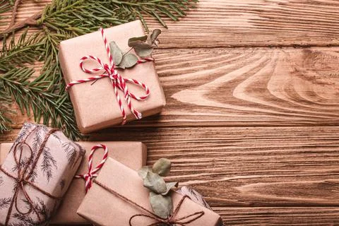 Wrapped Christmas presents flat lay composition with fir tree branch on wooden Stock Photos