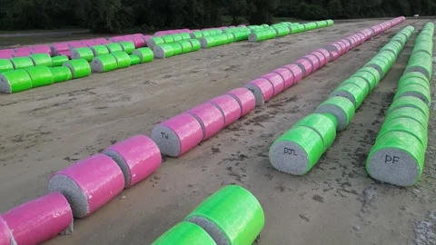 Wrapped cotton bales marked with identification codes arranged in parallel rows Stock-Footage 331459442