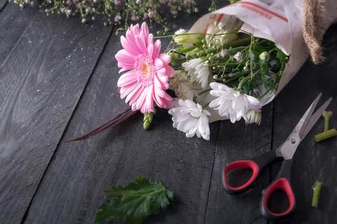 Wrapped flowers and scissors Stock Photos