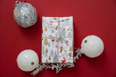 Wrapped gift box with silver bow, white balls gray baubles decoration Stock Photos