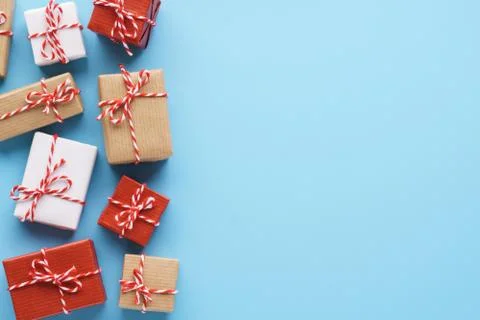 Wrapped gift boxes on light blue background. Stock Photos