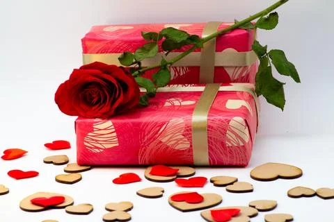 Wrapped gift boxes with a rose with small hearts all over Stock Photos