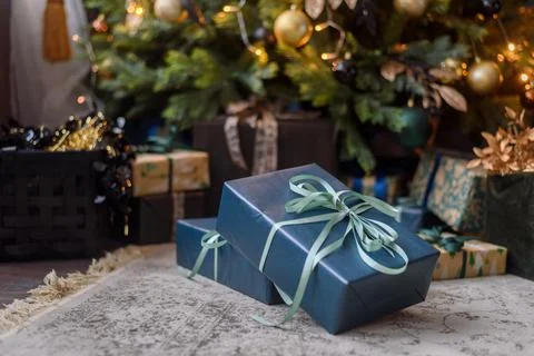 Wrapped gift boxes under Christmas tree Stock Photos