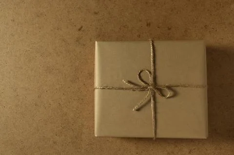 Wrapped gift sits on a textured surface ready for giving during a special Stock Photos