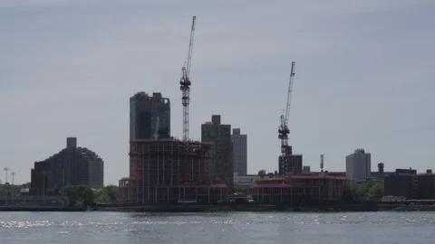 Wrapped in orange protective scaffolding two high rise buildings under const Stock Footage 242313876