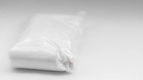 Wrapped package resting on a flat surface in minimalistic setting with soft.. Stock Photos