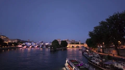 Wrapped Pont Neuf art installation on Seine River at dusk in Paris Stock Footage 336721397