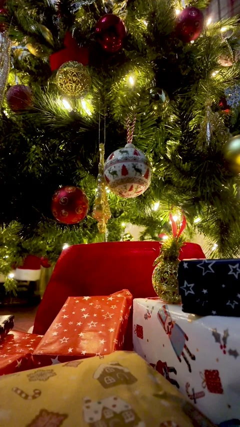 Wrapped presents under a glowing christmas tree. vertical video Vidéo 325829036
