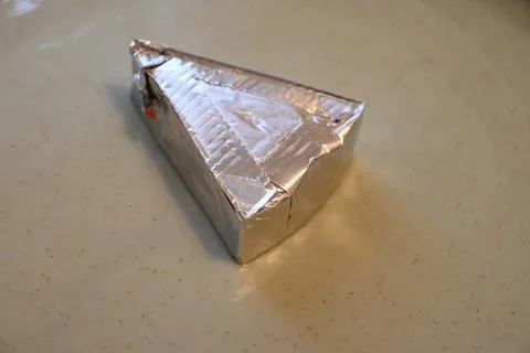 Wrapped processed cheese wedge Fotos Stock