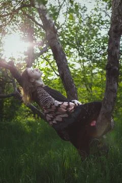 Wrapped with shawl lady lying on tree trunk scenic photography Stock Photos