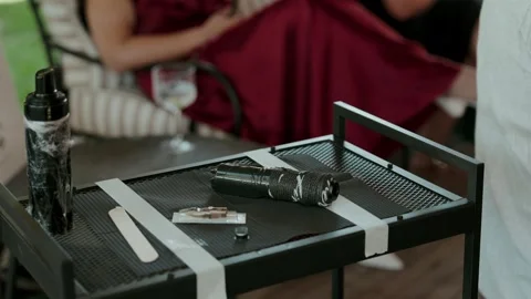 Wrapped Tattoo Machine and Supplies Laid Out on Metal Work Table Stock Footage 344013431