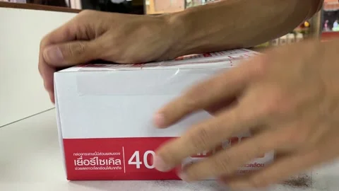 Wrapping the box at Thailand post office with sticky tape - Close up shot Stock Footage 172032096