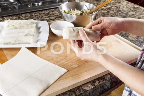 Wrapping up chinese spring roll Stock Photos