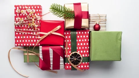 Wrapping Christmas gifts step by step on a white background. Stop motion video. Stock Footage 145530506