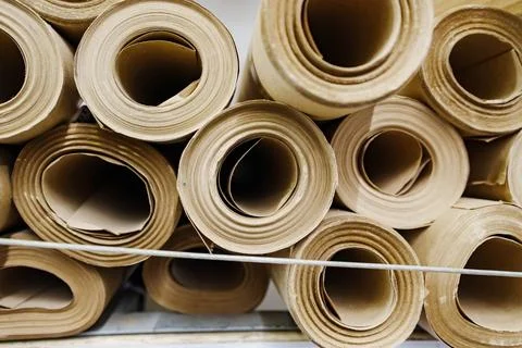 Wrapping craft paper cylinders pattern close up Stock Photos