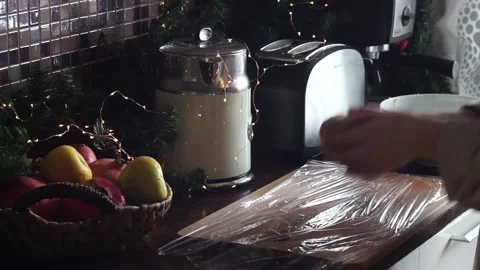 The wrapping of the dough for gingerbread cookies in plastic wrap. Stock Footage 130611315