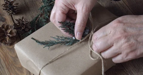 Wrapping an Eco Friendly Gift for the Holidays with Rustic Decorations Stock Footage 123809144