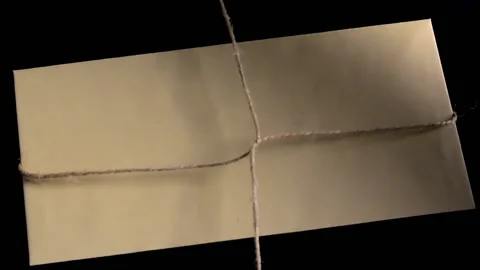 Wrapping the envelope with linen thread for subsequent sealing Stock Footage 132164764