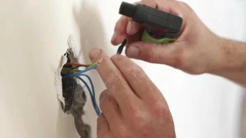 Wrapping exposed electric splicing with black insulating tape Stock Footage 339298368