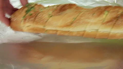 Wrapping Garlic Bread In Foil Stock Footage 1104045