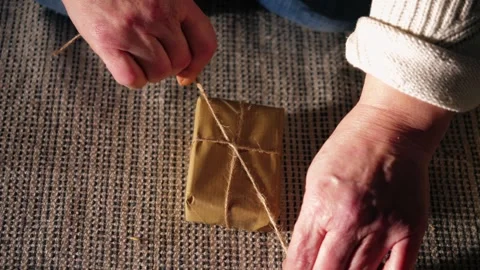 Wrapping gift in brown paper Stock Footage 296250318