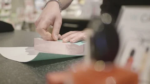 Wrapping a gift in a parfume store. Stock Footage 91780019