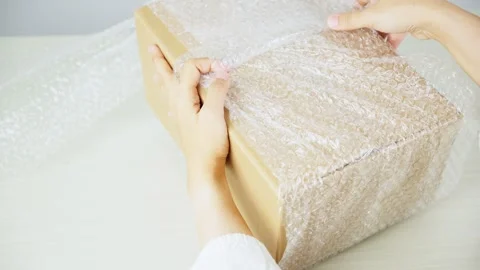 Wrapping Package With Bubble Wrap From Side View Video stock 347178905