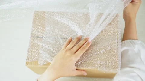 Wrapping Package With Bubble Wrap From Top View Video stock 347178906