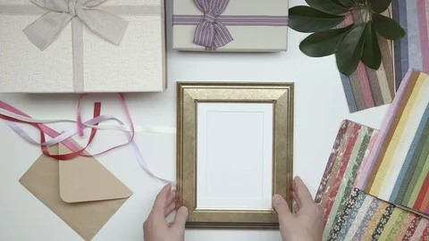 Wrapping photo frame as gift. 20. Stock Footage 102237440