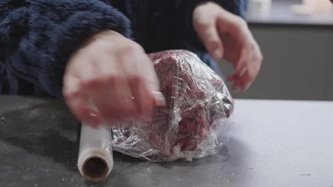 Wrapping Red Velvet Cookie Dough in Plastic Wrap Close Up Stock Footage 328893789
