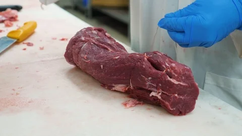 Wrapping the string around the fresh roast meat close up shot Stock Footage 104974260
