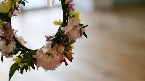 A wreath of delicate spring flowers in the hands of a woman. Slow motion Stock Footage 150503920