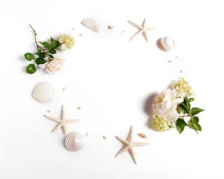 Wreath frame with roses, shells, starfish isolated on white background. flat lay Stock Photos