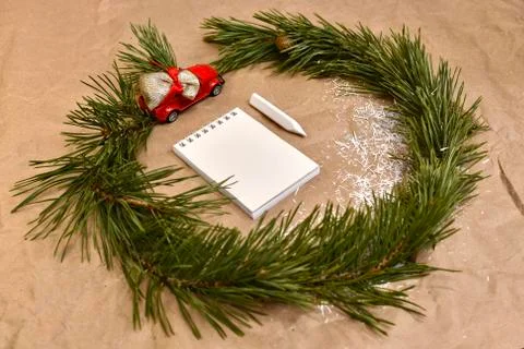 A wreath of pine branches with a red typewriter with a bag of gifts, around a 写真素材