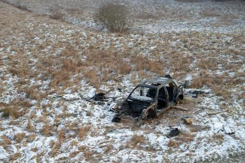 Wreck of a devastated car on a meadow. Disassembled car skeleton. Stock Photos