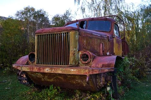 The wreckage of an old tracked all-terrain vehicle. Autumn landscape. Stock Photos