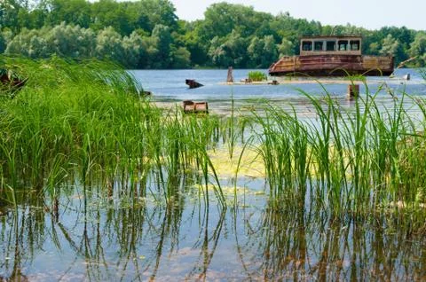 Wrecked abandoned ship on a river Stock Photos
