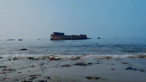 Wrecked and Rusty Cargo Barge on a Polluted Beach in Asia Stock Footage 337803770