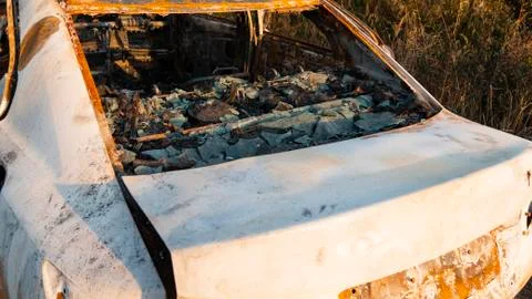 Wrecked car after an explosion or severe fire.Melted glass in a burned out car. Stock Photos
