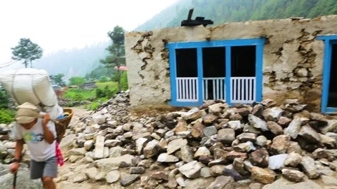 Wrecked house with rocks in the foreground Stock Footage 77446117