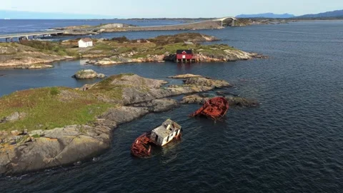 Wrecked ship crumbles on wave-battered rocks off Norway, drone view Stock Footage 320732468