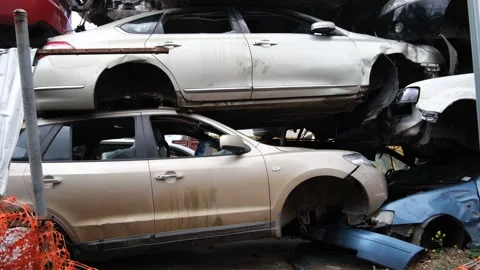 A wrecking yard with a large pile of abandoned and damaged cars in Australia Stock Footage 295330049