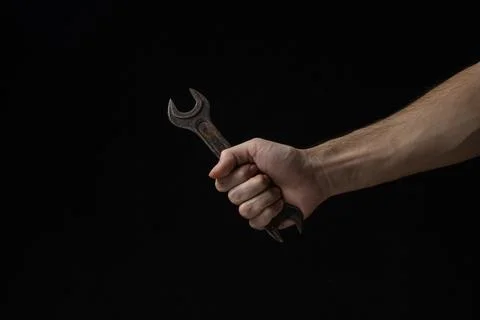 Wrench on a black background. Old work tool.  Stock Photos
