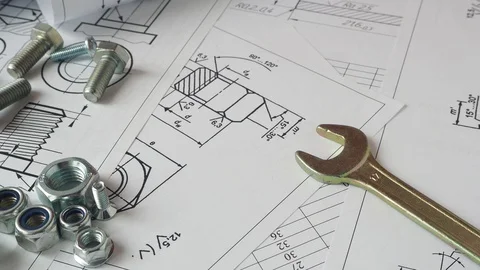 Wrench, bolts and nuts on background of engineering drawings. Stock Footage 129731683