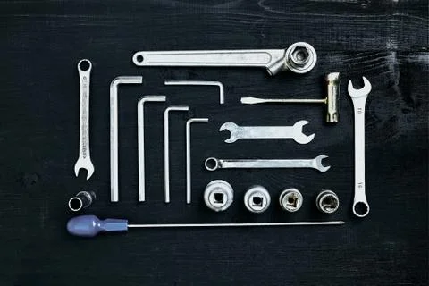 Wrench set of pliers socket spanner and screwdriver tools on black wooden Stock Photos