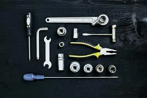 Wrench set of pliers socket spanner and screwdriver tools on black wooden Stock Photos