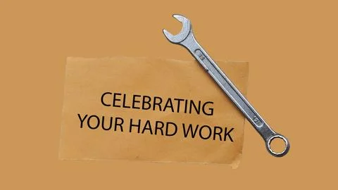 Wrench tool with text celebrating your hard work on brown paper card Stock Photos