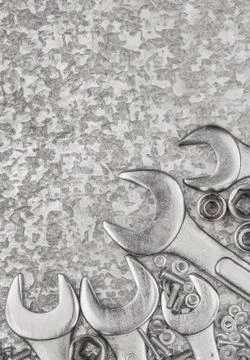 Wrenches and tools on a metallic background Stock Photos