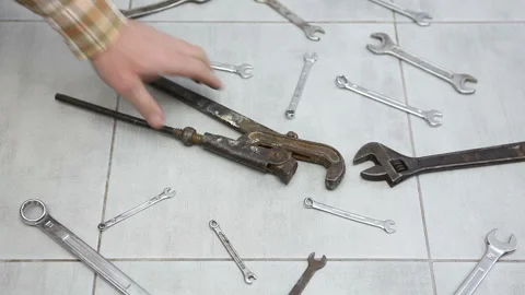 Wrenches of different sizes are scattered on the ceramic floor.  Stock Footage 241266286